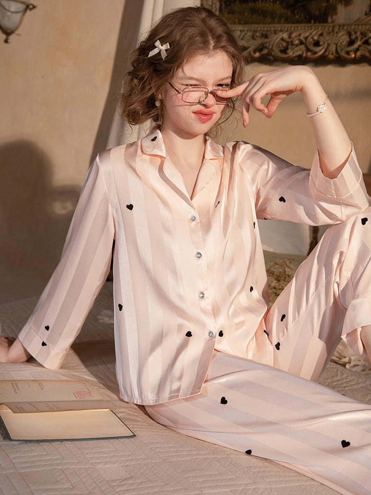 Pink satin shirt pants pajama set seated view