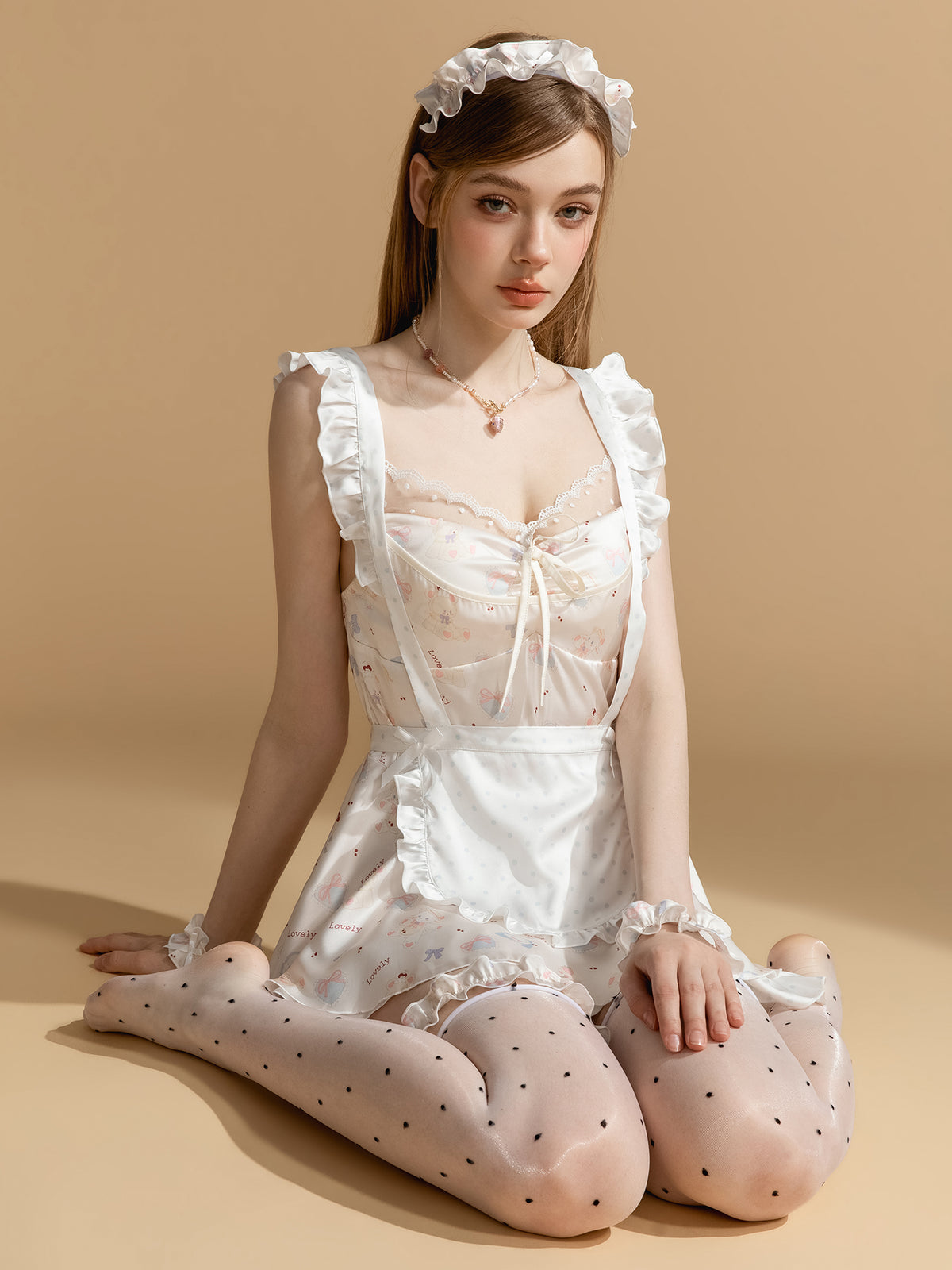 Ivory bow print maid nightdress and apron shown seated