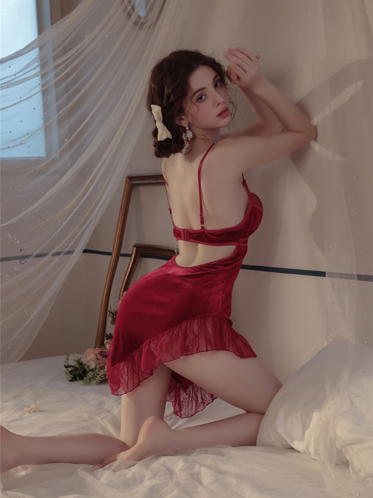 Woman in a red Velvet Lace Cutout Spaghetti Strap Slip Dress posing in a softly lit room with sheer curtains.