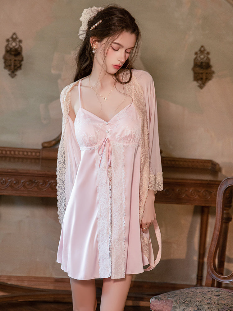 Woman wearing a pink satin nightgown with lace details in an elegant room. Pink Lace Panel Tie Front Chemise Robe Set