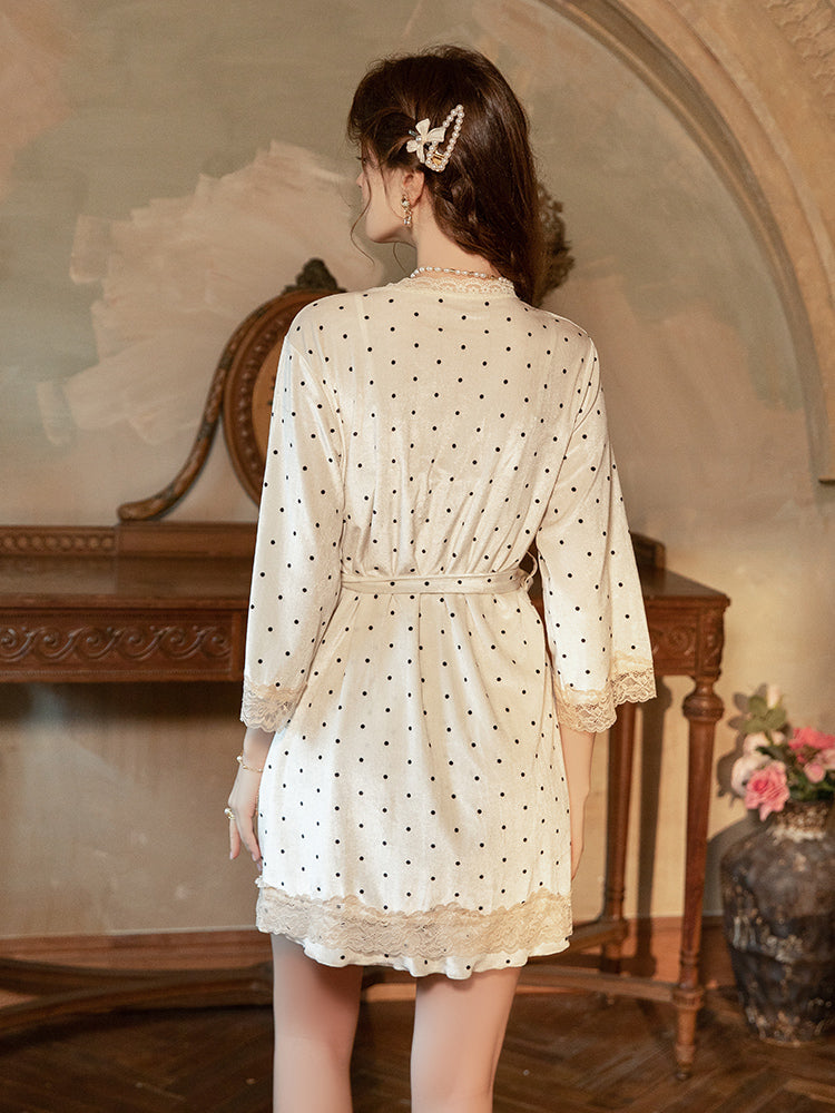Woman wearing a polka dot dress in an elegant room with a mirror and decorative elements.