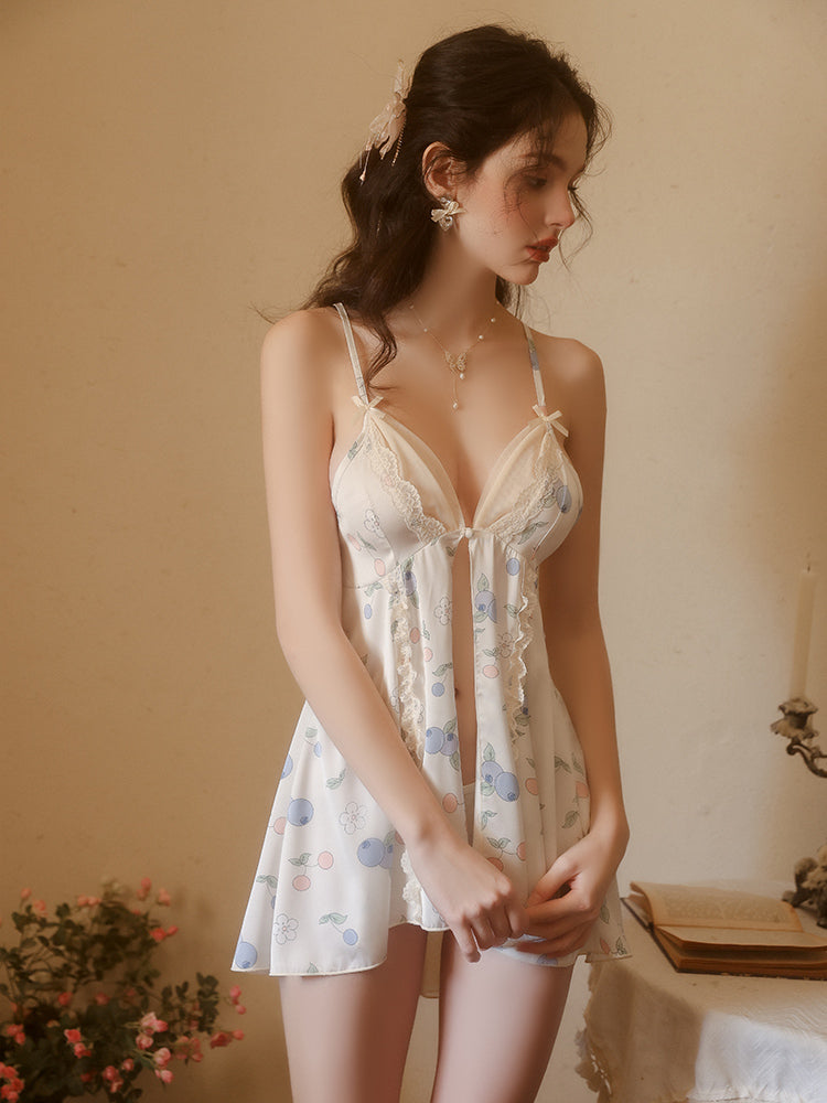 Woman wearing a floral nightgown in a softly lit room.