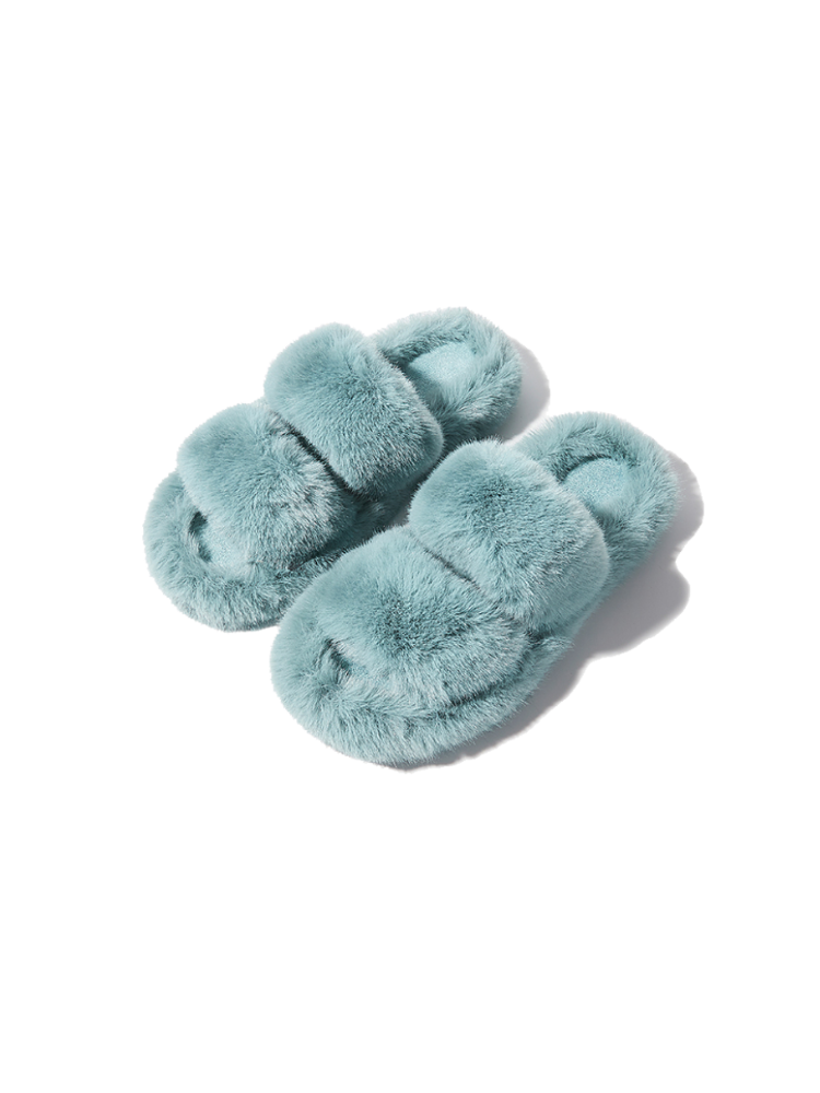 Blue fuzzy slippers front view placed on white background soft fur