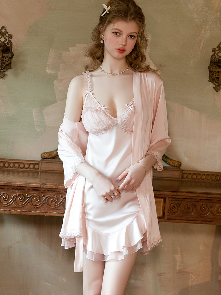 Woman wearing a vintage-style pink lingerie set with a matching robe in an elegant room. satin mini dress, slip dress, babydoll dress, white slip dress, open back dress, ruffle mini dress, lace trim sleep dress.