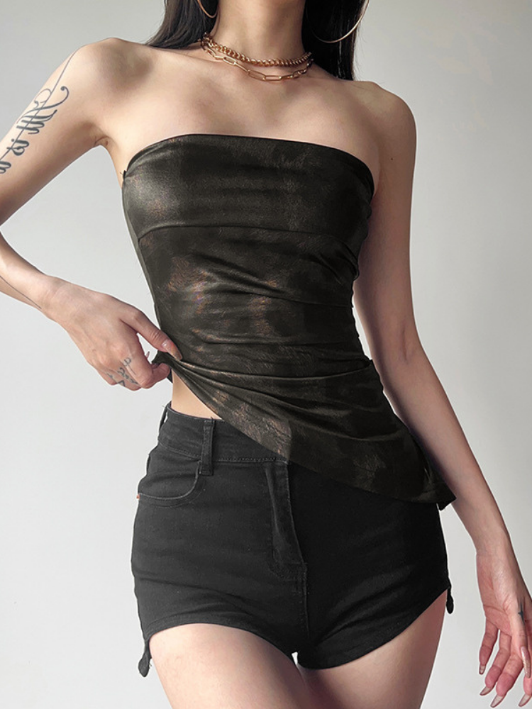 Person wearing a black strapless top and black shorts on a plain background