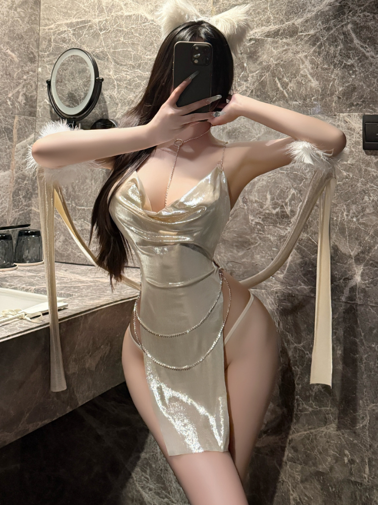 Person wearing a Gold Metallic Halter Neck Mini Dress Set with High Slit taking a mirror selfie in a marble bathroom.