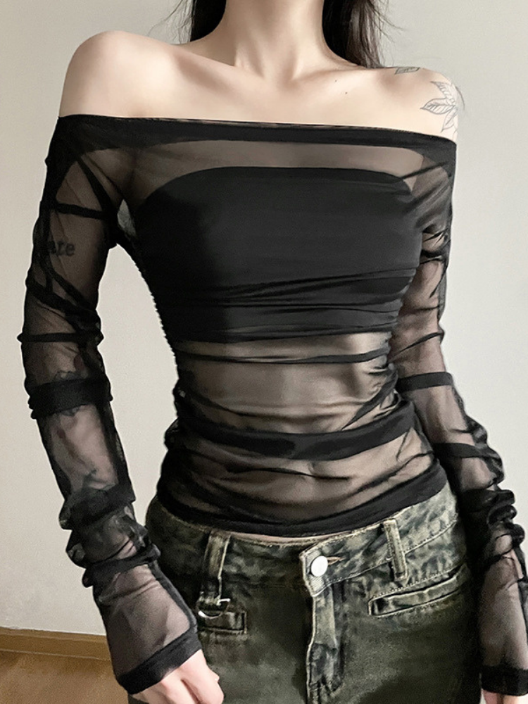 Black off-shoulder top with sheer sleeves worn by a person against a neutral background