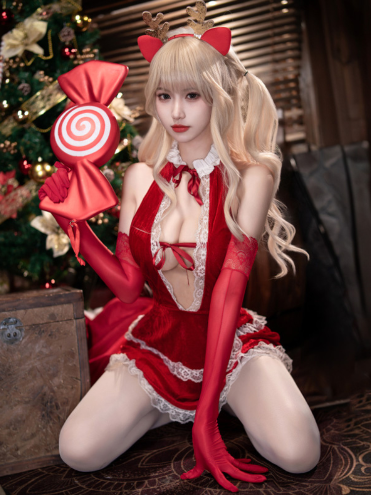 Person in a Velvet Lace Plunge Red Christmas Lingerie Dress Sexy Santa Babydoll, sitting in front of a decorated Christmas tree.