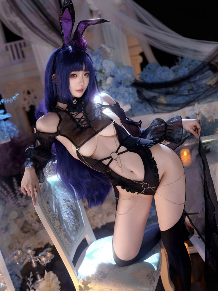 Person in a Black Sheer Lace Cutout Bunny Costume Sexy Lingerie Bodysuit with bunny ears in an elegant interior setting