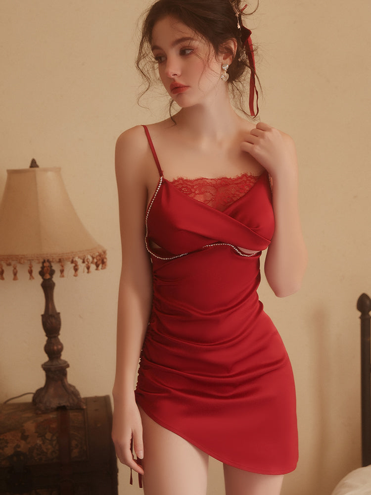 Woman wearing a red dress with lace details in a room setting.
