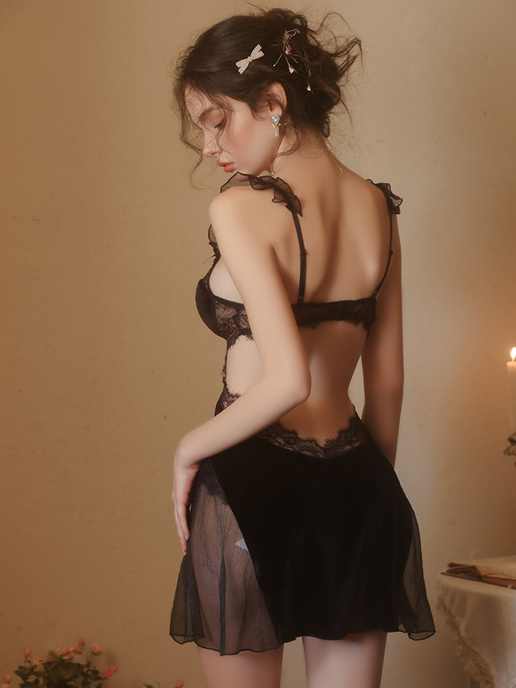 Woman wearing a black Lace Corset Bodice Velvet Slip Dress against a warm-toned background
