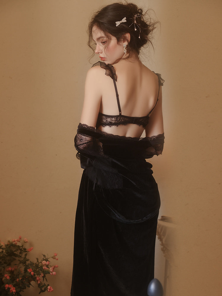 Woman wearing a black Lace Corset Bodice Velvet Slip Dress against a beige wall.