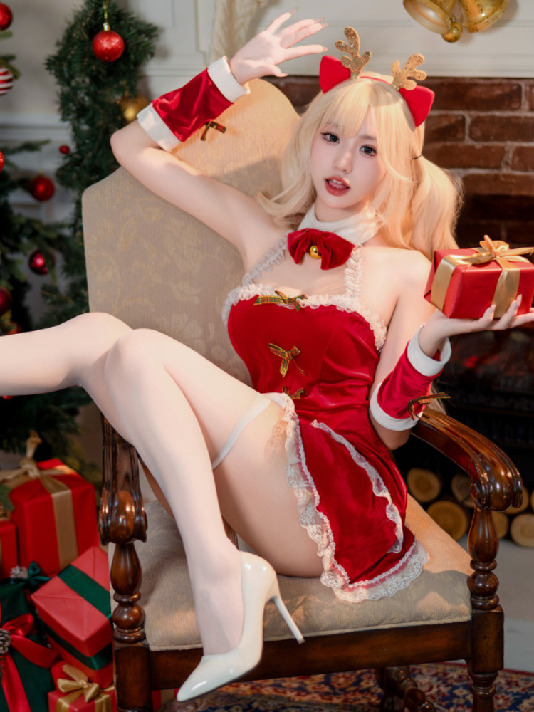 Person in a velvet Lace Bow Red Christmas Lingerie Dress Halter Mini Babydoll with reindeer ears and a red dress, sitting on a chair with Christmas decorations.