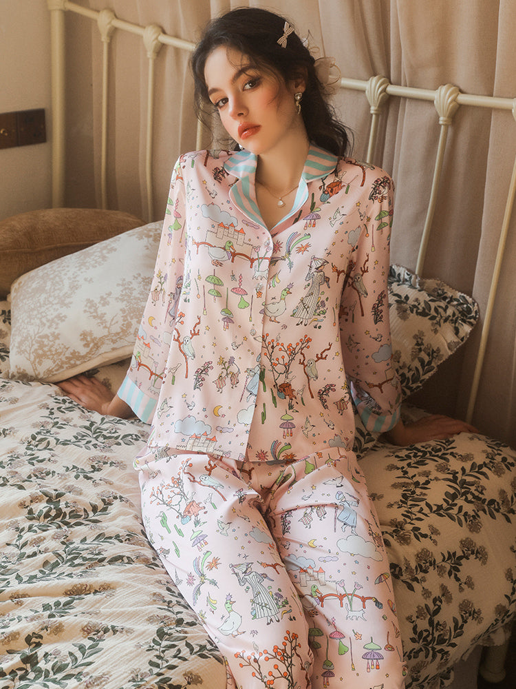 pink cartoon pajama sets seated front view on bed