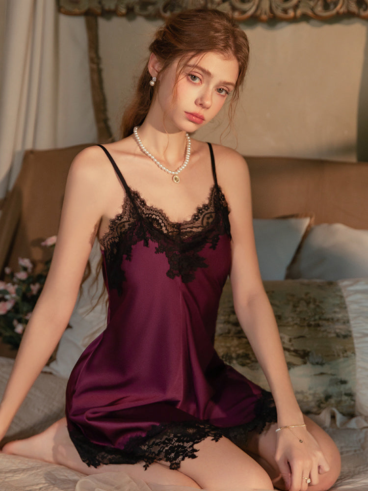 Woman wearing a purple Lace Trim Satin Spaghetti Strap Slip Dress sitting on a bed.