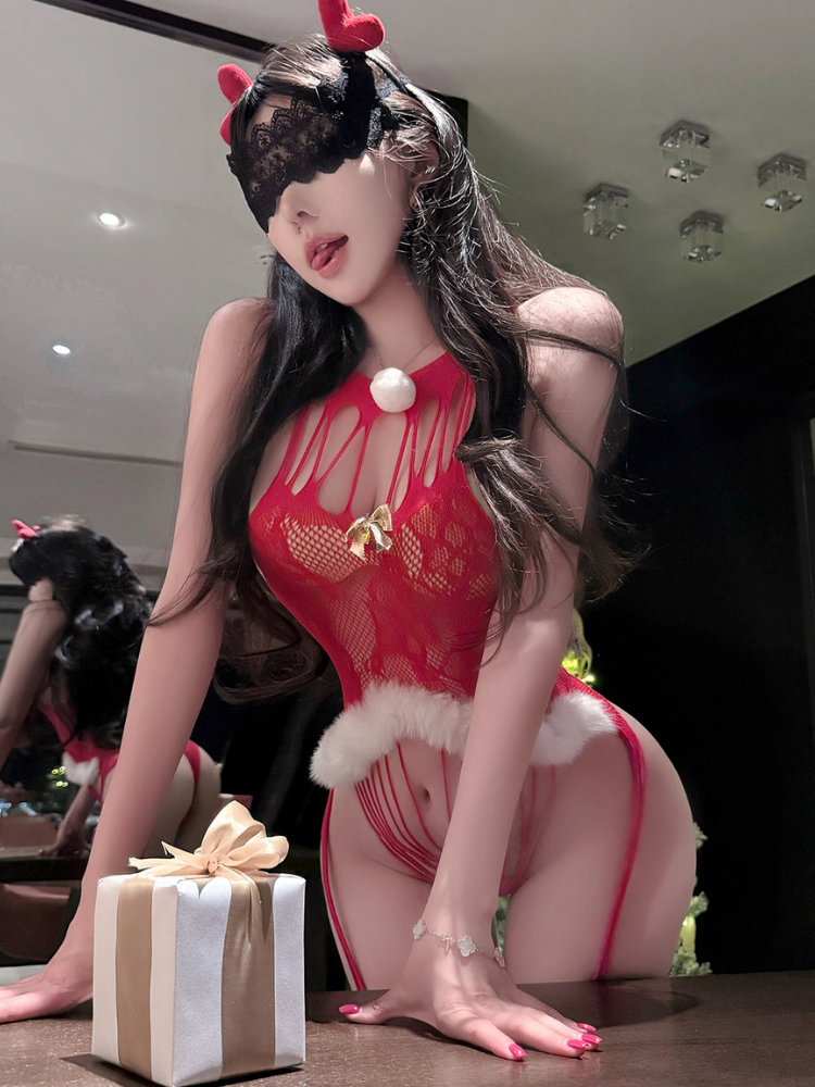 Person in a Red Lace Sexy Lingerie Bodysuit Women Christmas Santa Outfit, sitting on a table with a gift box.