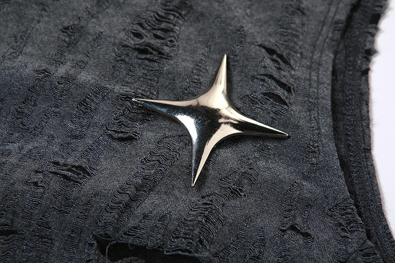 Silver star-shaped brooch on a textured black fabric background