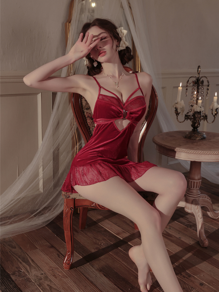 Woman in a red Velvet Lace Cutout Spaghetti Strap Slip Dress sitting on a chair in a vintage-style room.