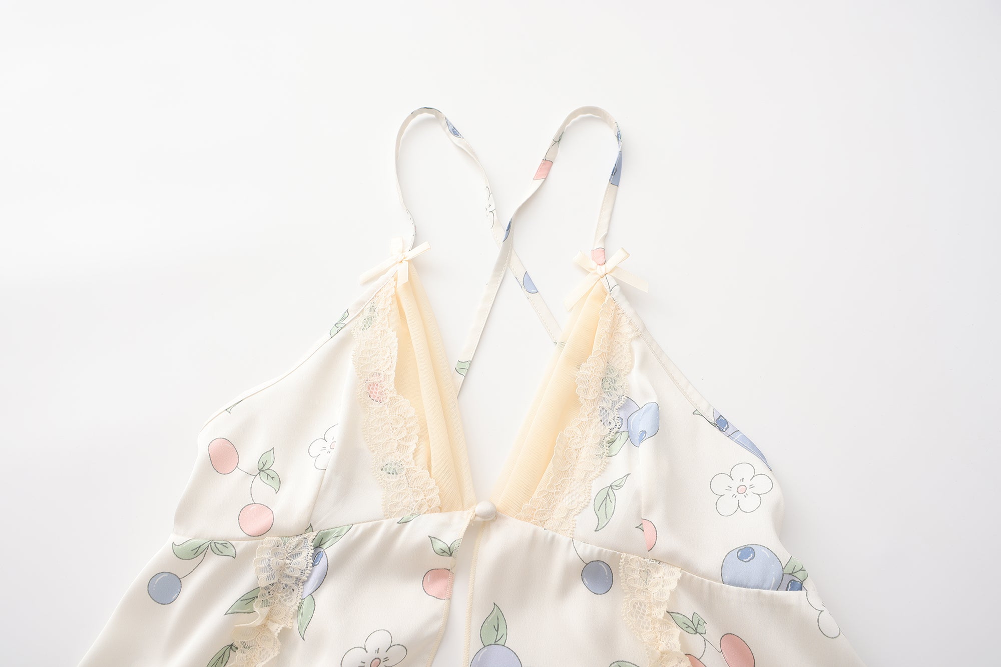 Floral dress on a hanger against a white background