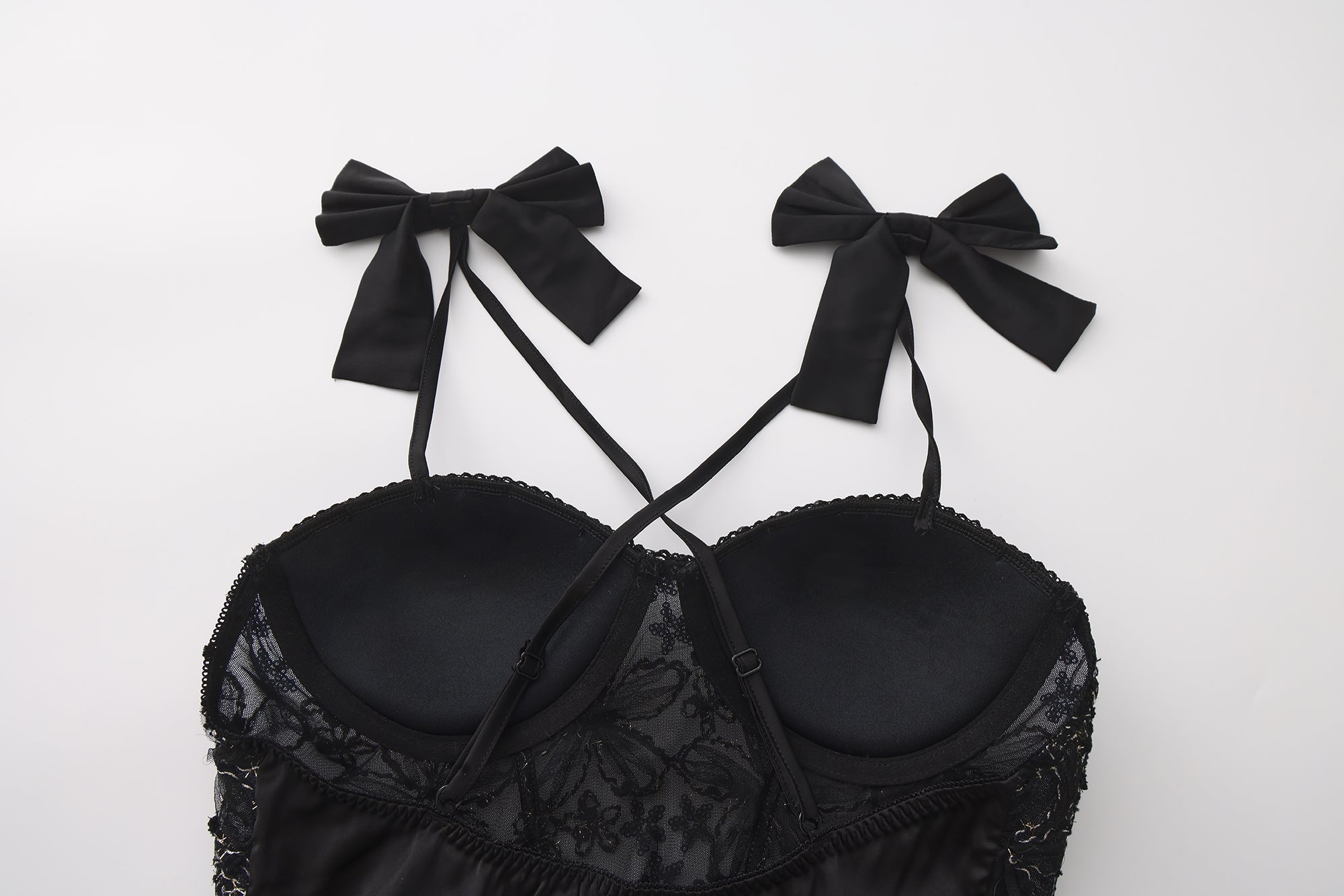 Black lace bra with velvet bows on a white background