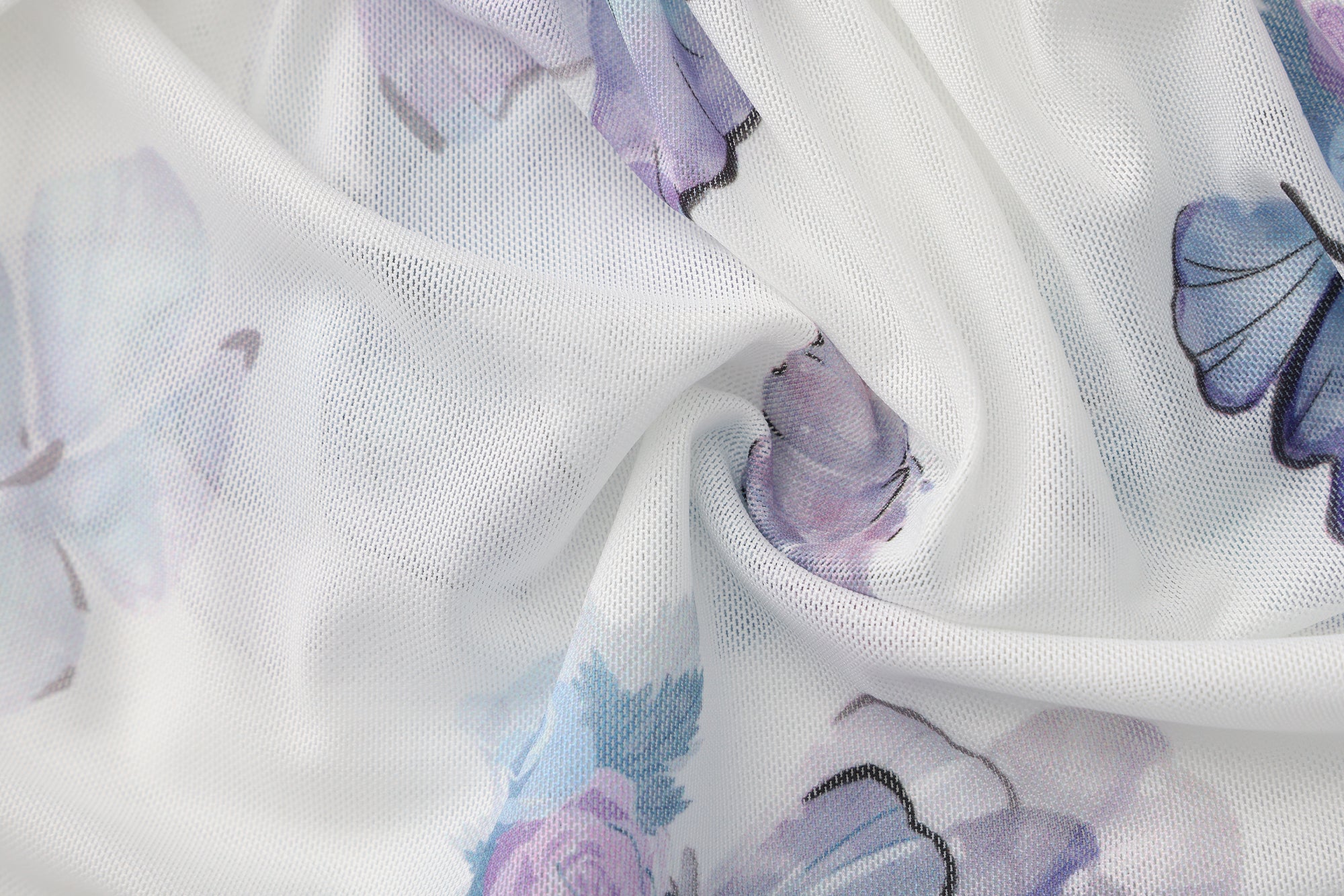Close-up of fabric with butterfly pattern on a white background