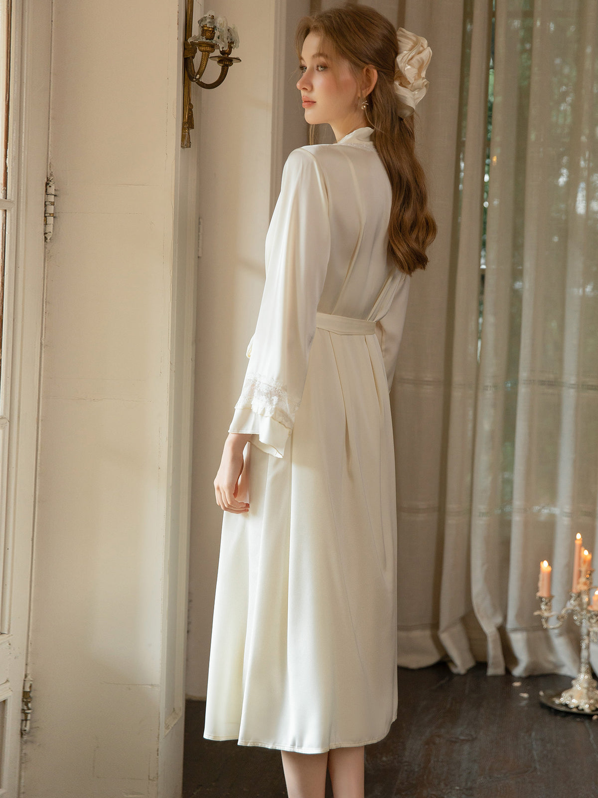 White satin midi robe angled rear view showing tie belt and lace sleeve cuffs