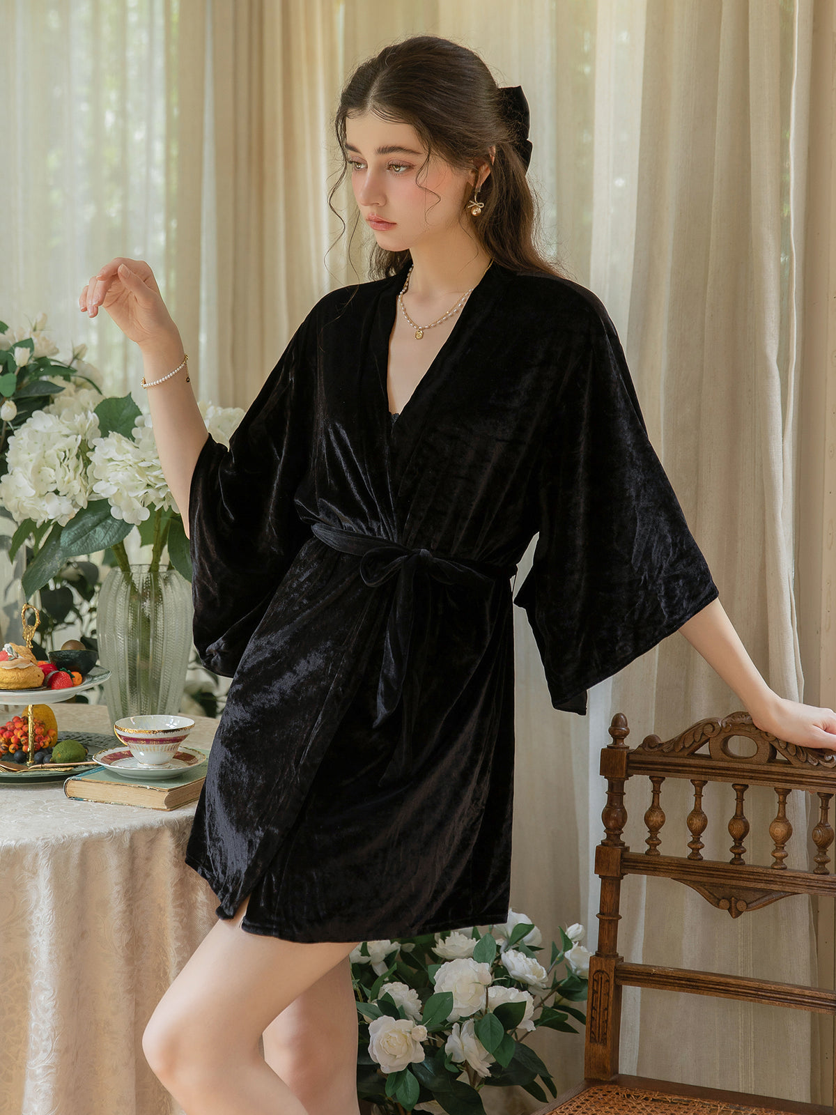 Black short velvet robe front view showing wrap opening, waist tie and wide sleeves