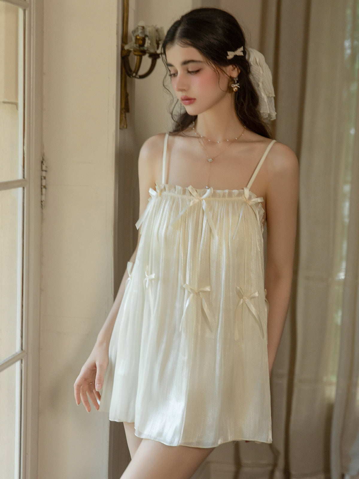 Front view of ivory ribbon bow nightgown and sheer overlay