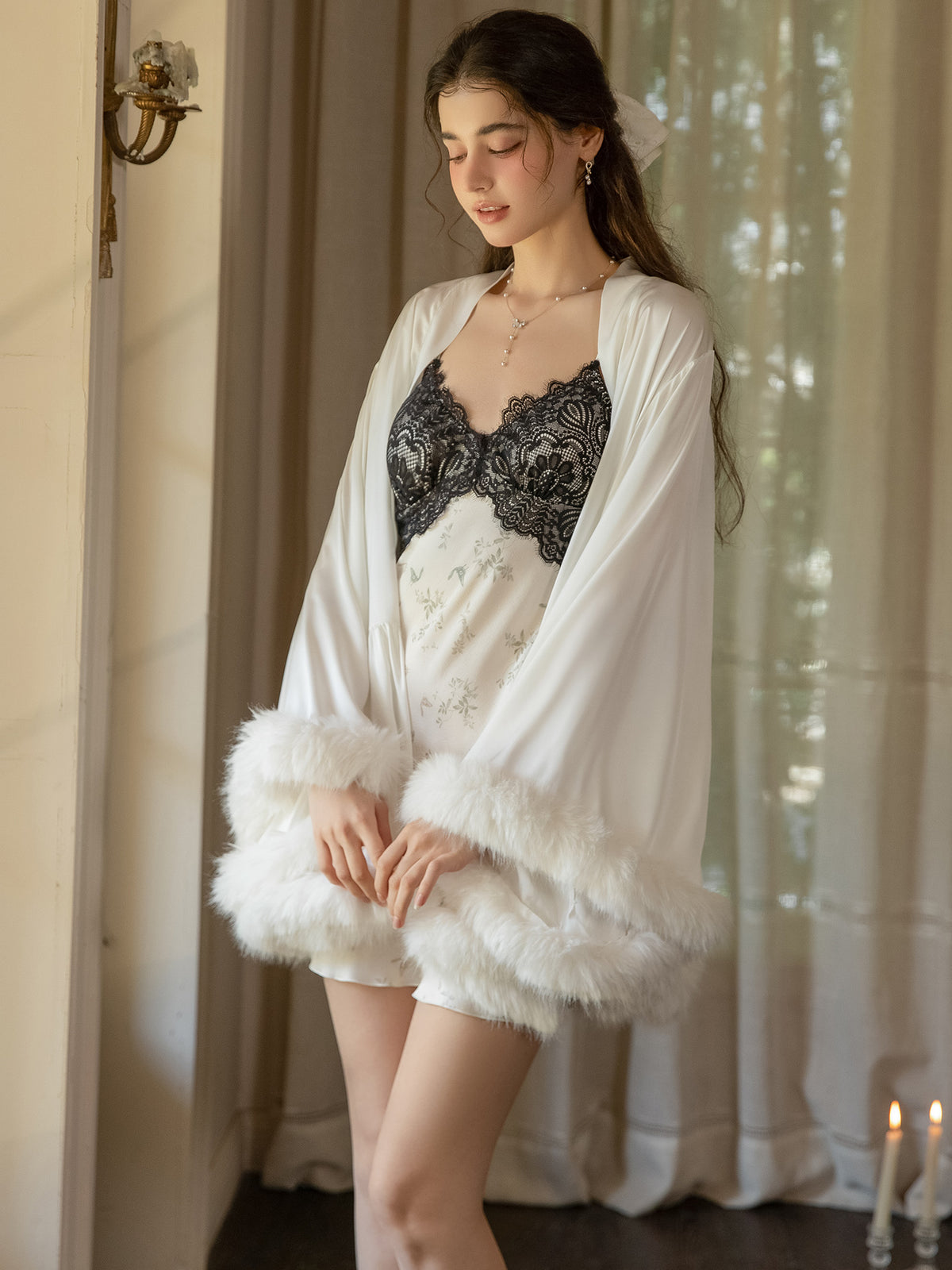 White Robe showing fluffy cuffs and hem beside separate floral Dress