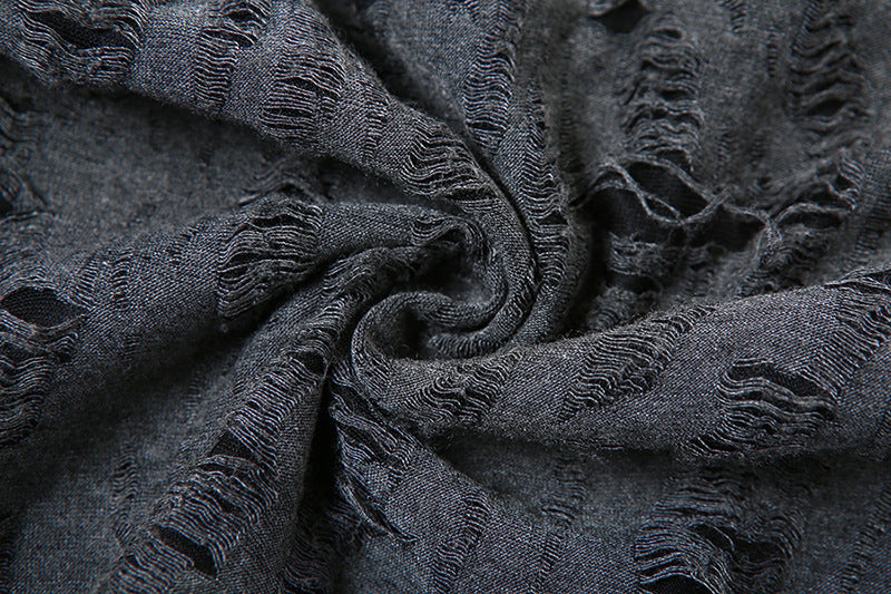 Close-up of textured dark gray fabric with fringes