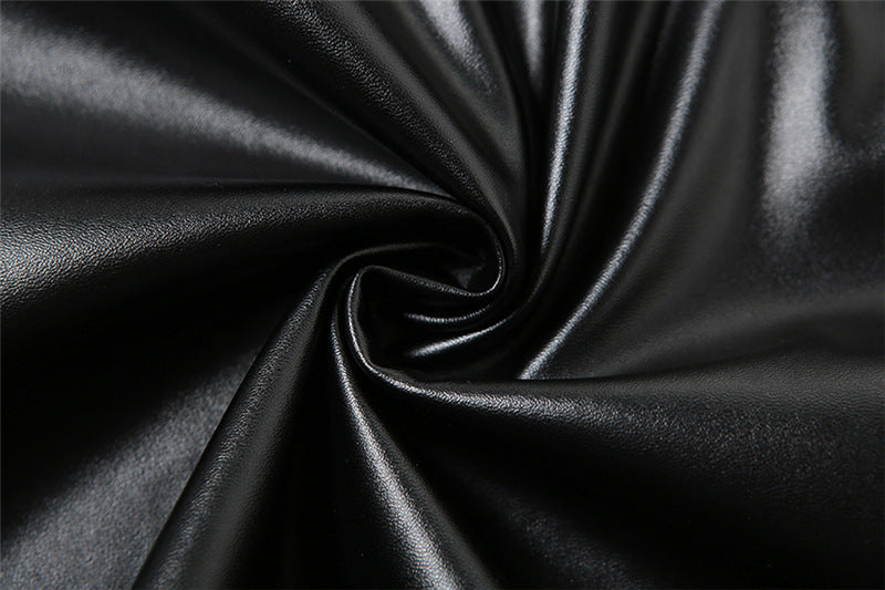 Close-up of black satin fabric with folds