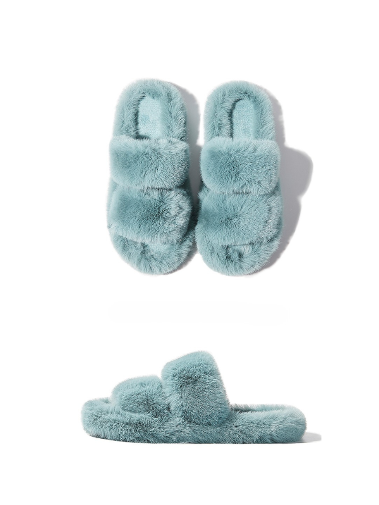 Blue fuzzy slippers front and side view placed on white background soft fur