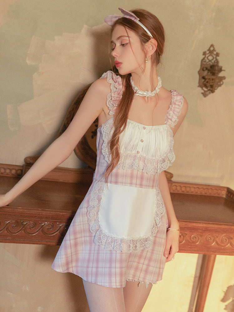 Woman wearing a Pink Plaid Lace Maid Babydoll Mini Dress in a softly lit room.