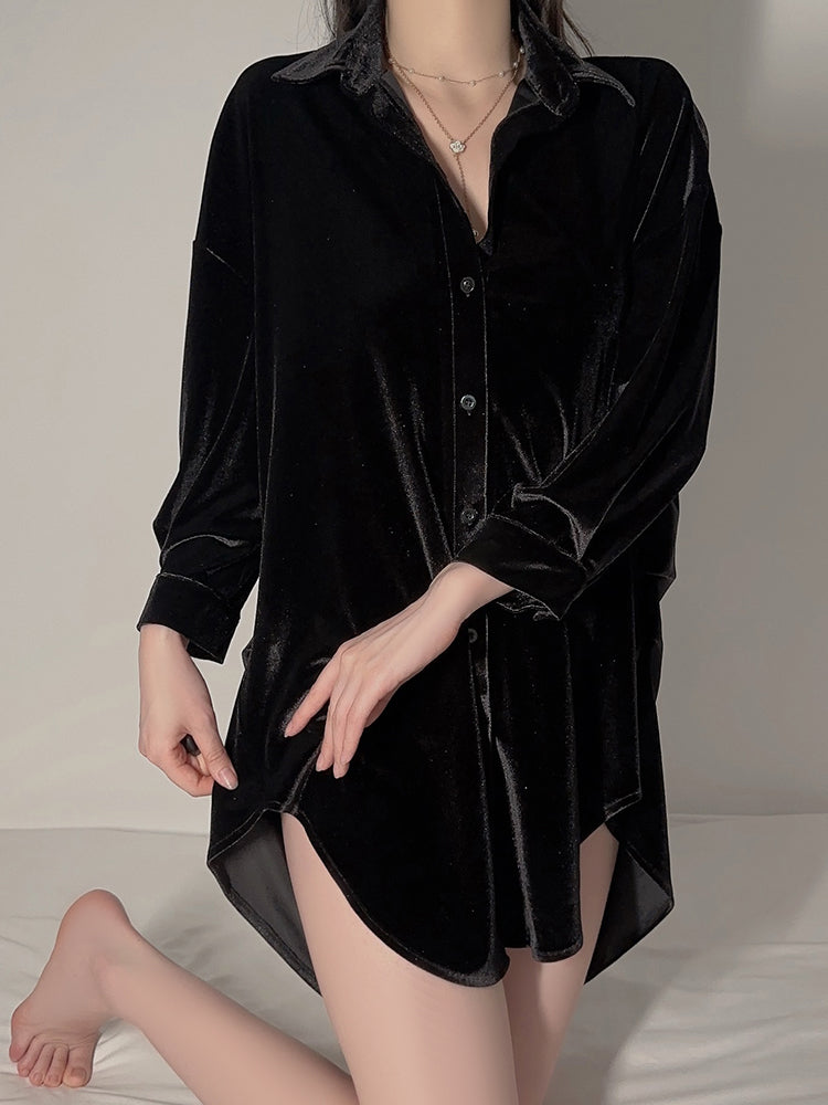 Model standing in black velvet button down shirt dress with rounded hem design