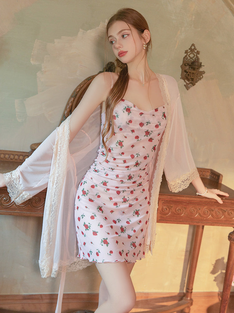Woman wearing a Pink Rose Floral Mesh Ruched Mini Dress with a sheer cover-up in a vintage-style room.