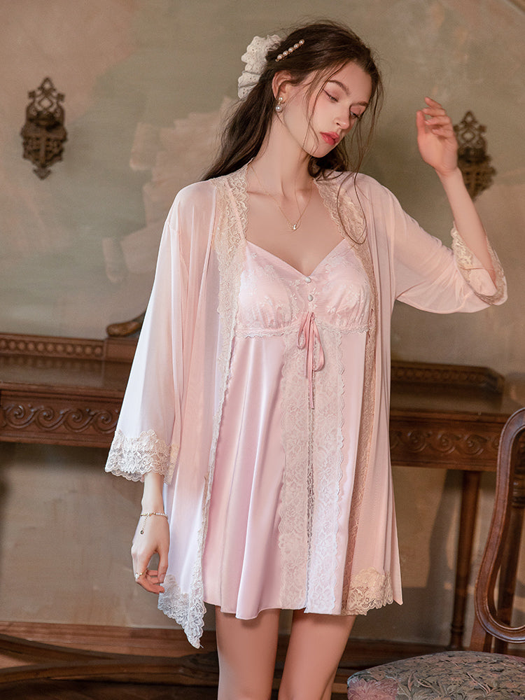 Woman wearing a pink satin nightgown with lace details in a vintage room. Pink Lace Panel Tie Front Chemise Robe Set