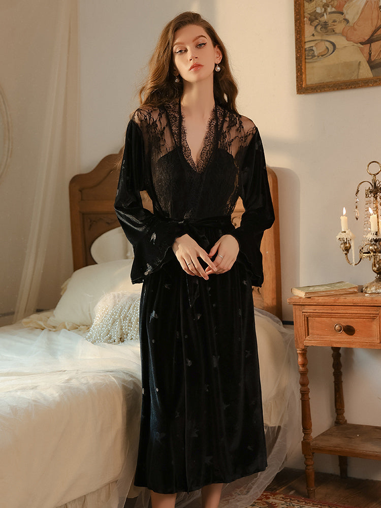 Black butterfly velvet dress and robe worn together near candles