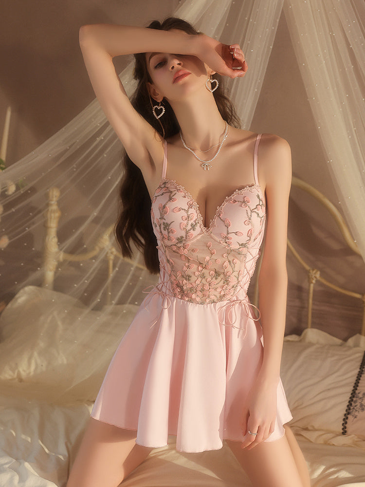 Woman wearing a pink floral dress in a softly lit room