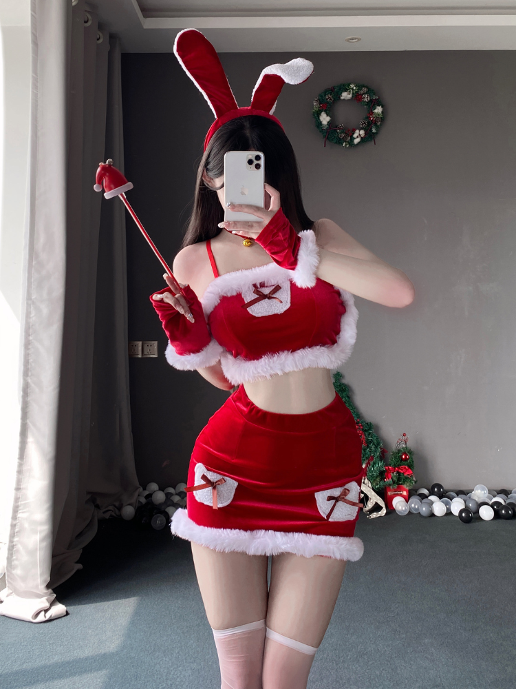 Two piece bunny costume with furry trim and bow details, featuring a cropped top and mini skirt, styled with a bunny ear headband and matching gloves.