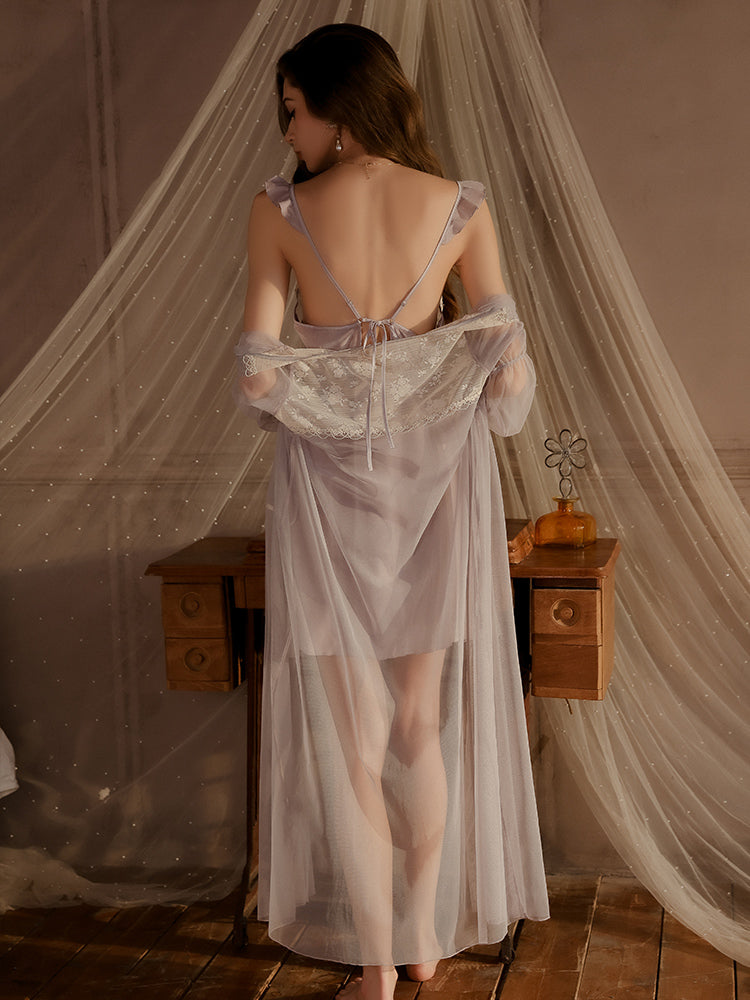 Back standing view of floral embroidered lace slip dress in lavender color with sheer overlay