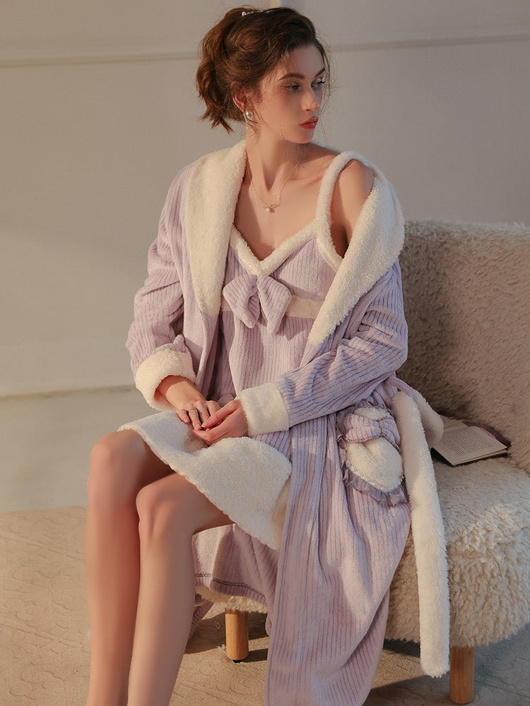 Model seated in a cozy chair wearing a lavender textured robe set with soft bow embellishments and fluffy accents - Plush Textured Robe Set with Bow Pocket Details.