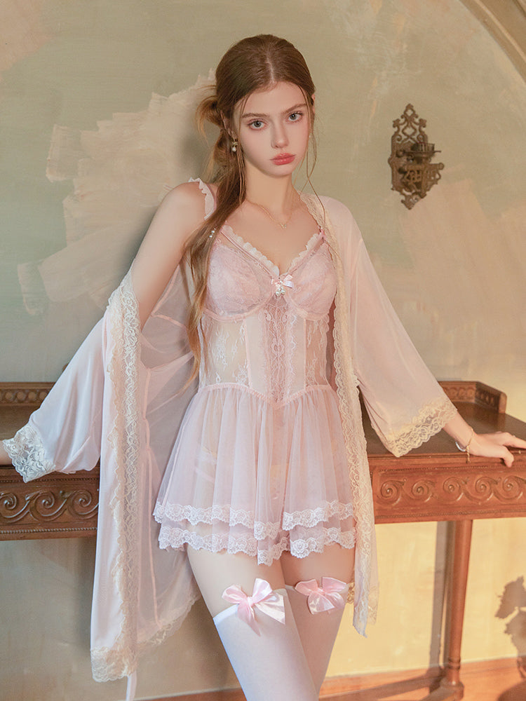 Woman in a vintage-style pink Lace Lingerie Babydoll Mini Dress set with a matching robe in an elegant room.