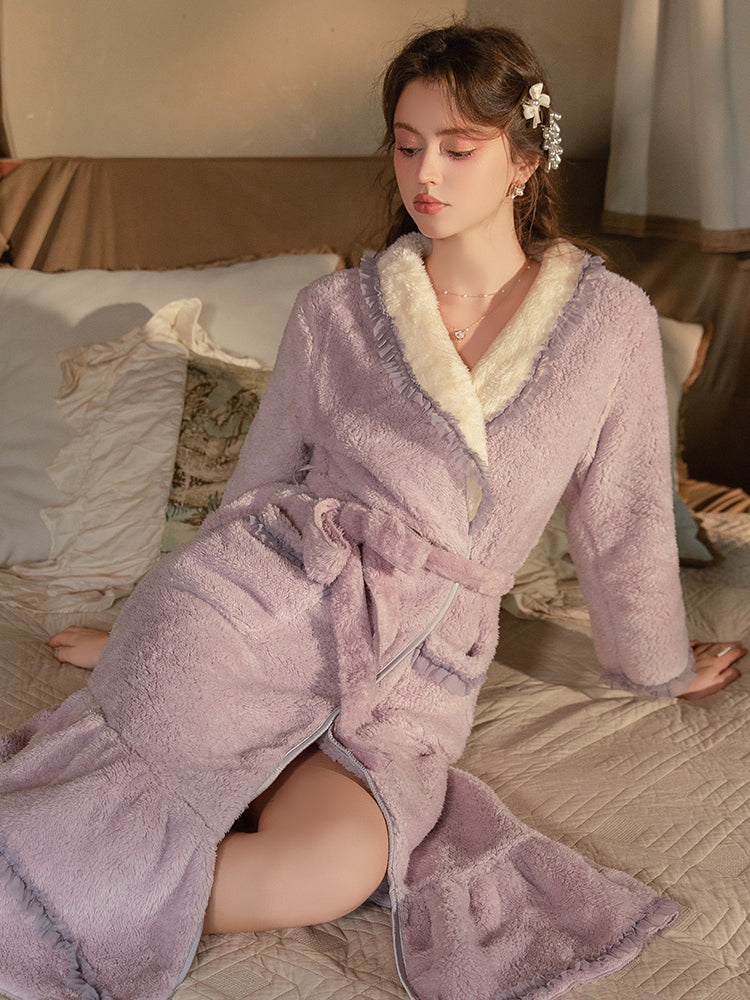 Woman wearing a Plush Fleece Ruffle Hem Long Bath Robe Purple sitting on a bed.