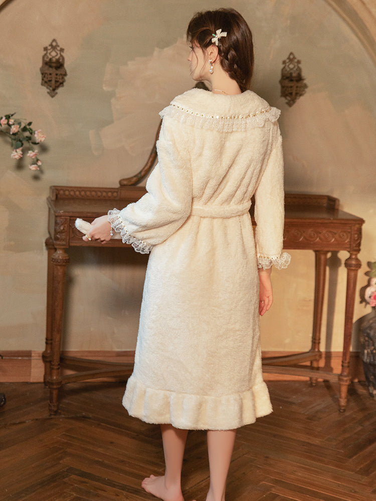 Woman in a vintage-style white dress standing in an elegant room with wooden furniture.