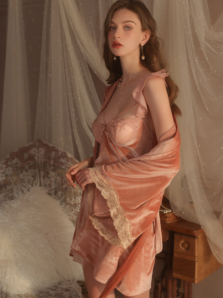 Side view of a standing model showcasing a rose gold velvet slip dress with lace details, styled with a matching rose gold robe, exuding a soft, romantic charm.