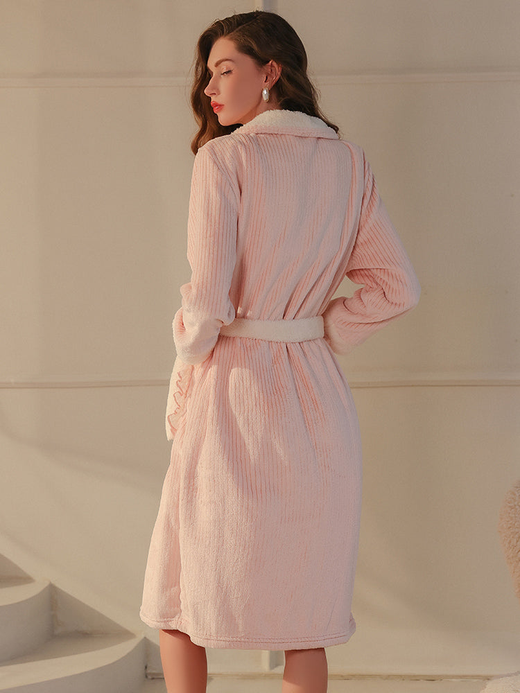 The back design of the pink plush textured robe featuring a textured fabric and fleece lining, model highlighting the silhouette.