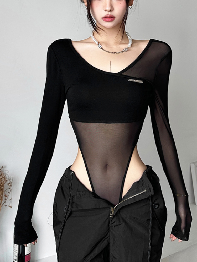 Person wearing a black long-sleeve top with mesh panels and a black jacket.