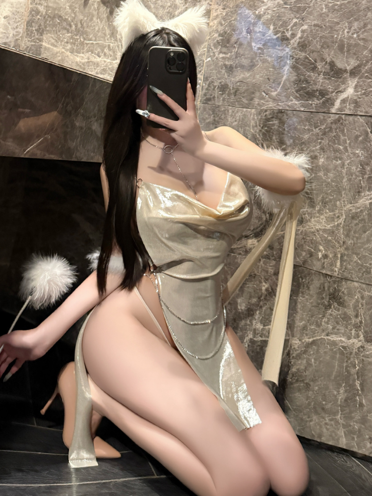 Person wearing a Gold Metallic Halter Neck Mini Dress Set with white fur accents in a room with marble walls.