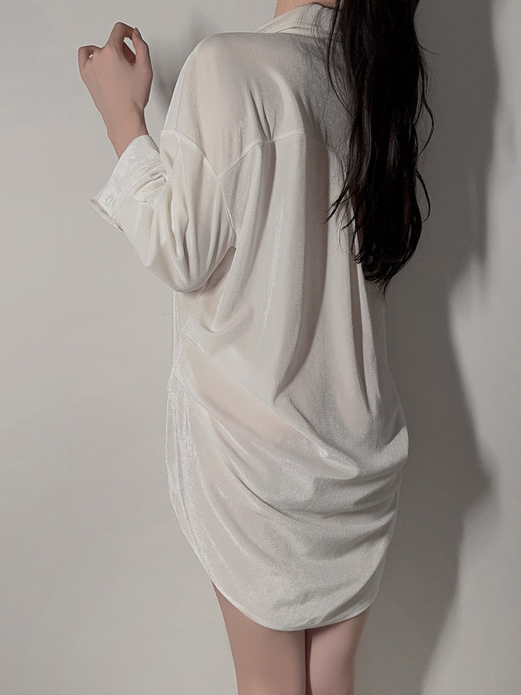 Back view of model standing in white velvet button down shirt dress with rounded hem design 