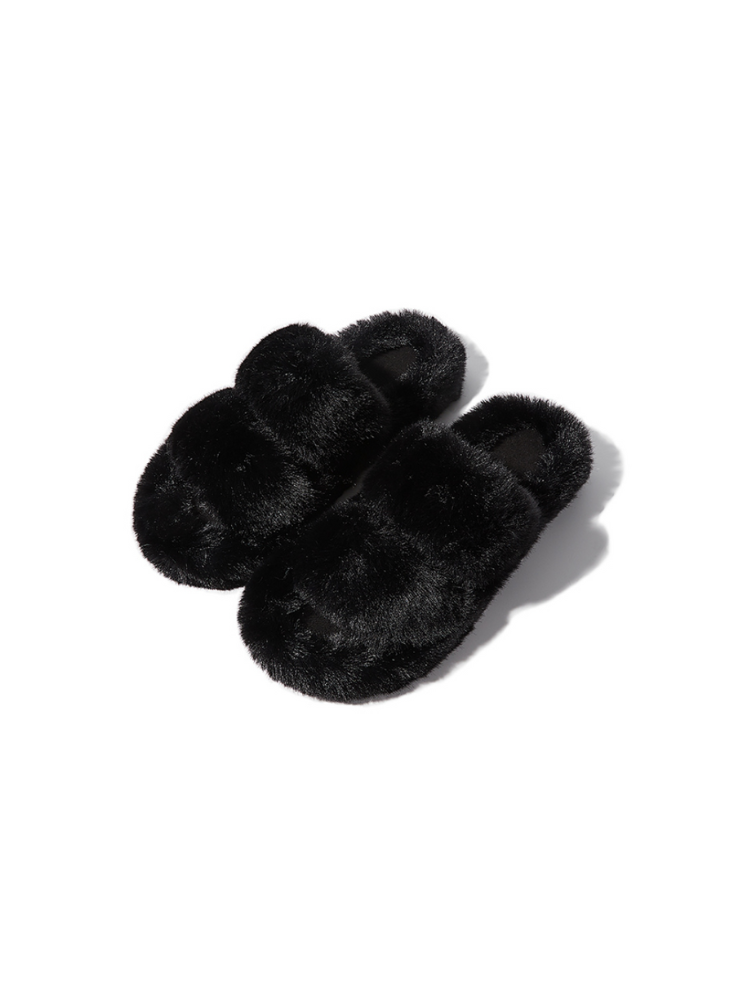 Black fuzzy slippers front view placed on surface plush texture